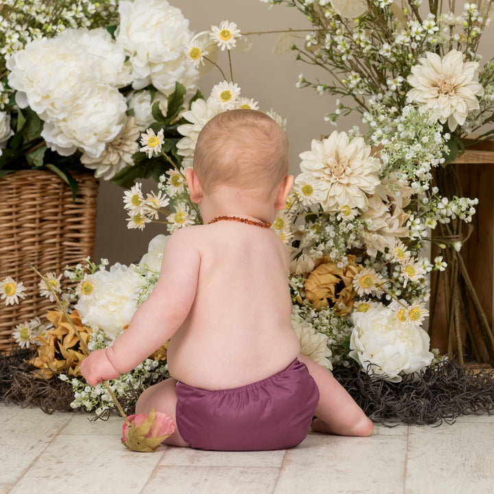 Baby wearing Onesize Reusable Pocket Nappy in Aubergine by LittleLamb#color_aubergine