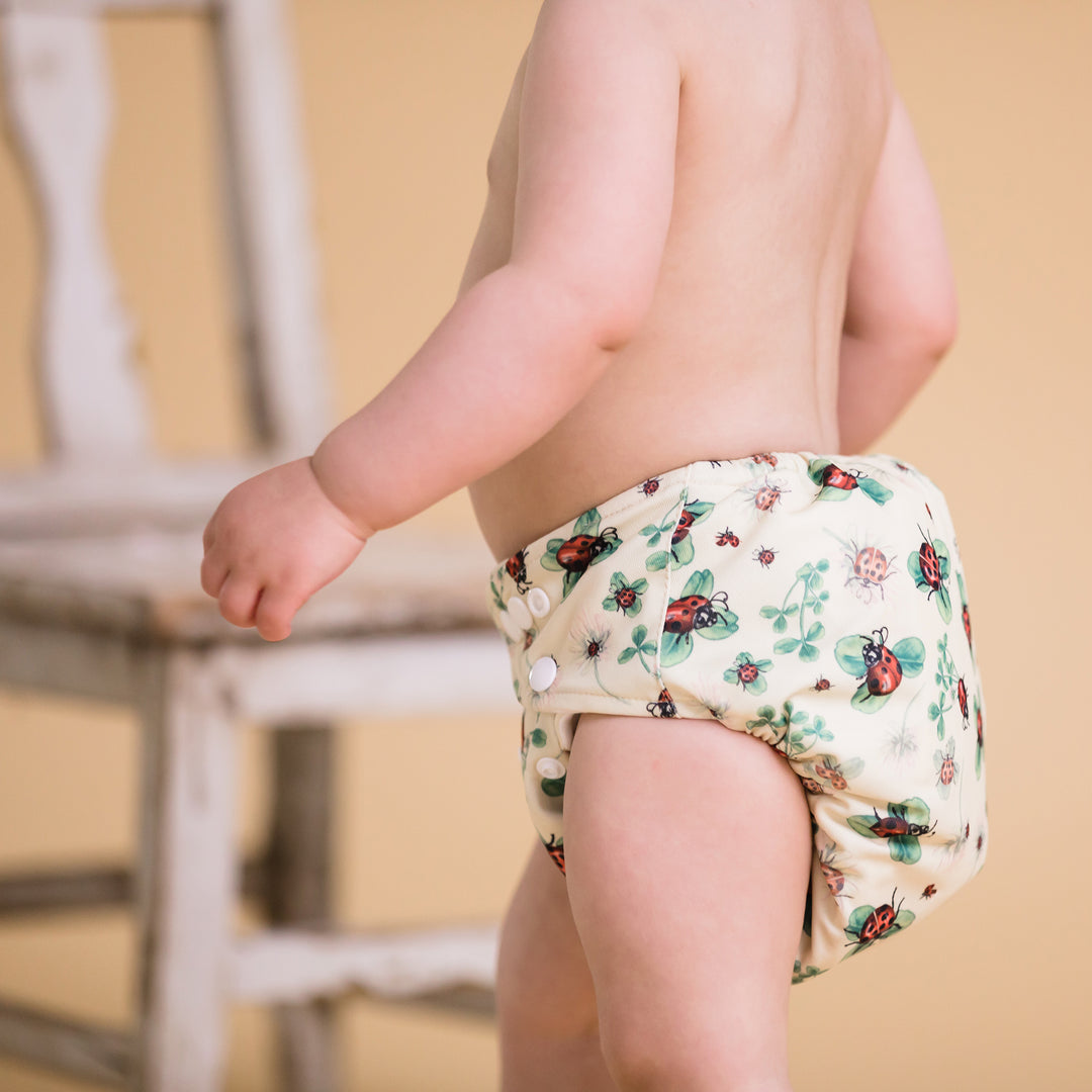 Toddler wearing Onesize Reusable Pocket Nappy with ladybird illustrations by LittleLamb#color_ladybugs-lullaby