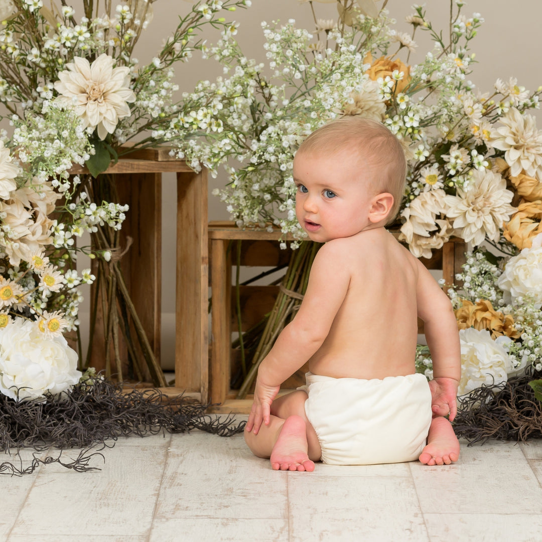 Baby wearing Onesize Reusable Pocket Nappy in cream by LittleLamb#color_cream