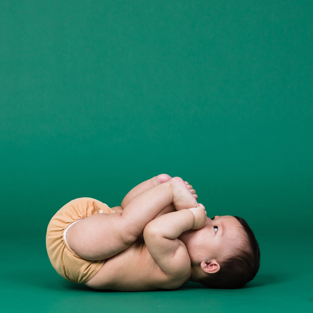 Baby wearing Onesize Reusable Pocket Nappy in Sand by LittleLamb#color_sand