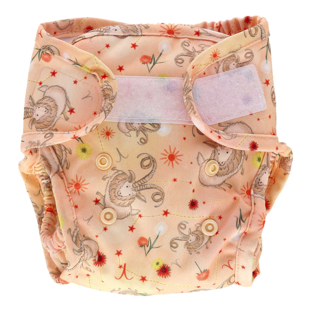 Little Lamb reusable cloth nappies - Aries pattern - coral nappy with goats and Aries star sign - front view