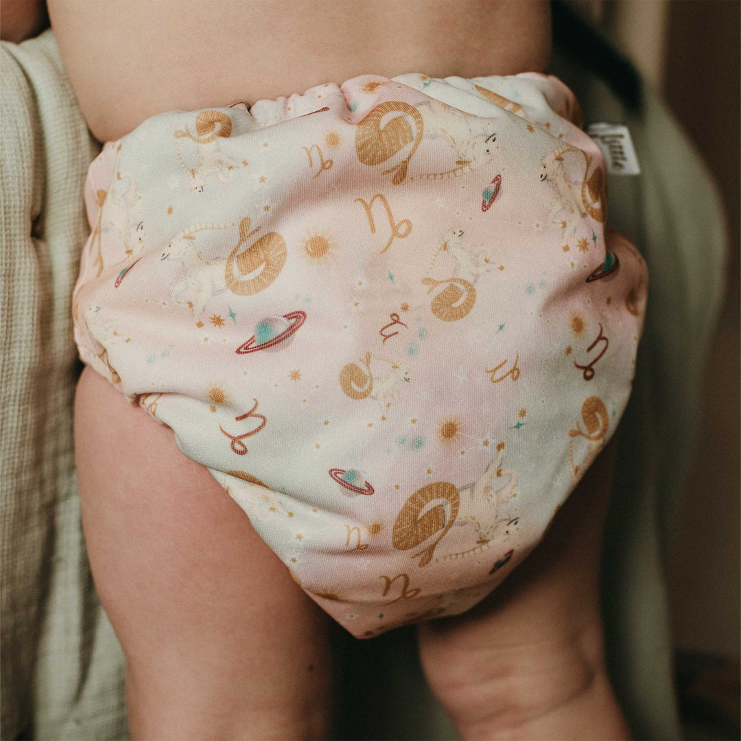 Baby wearing a Capricorn Onesize Pocket Nappy by LittleLamb